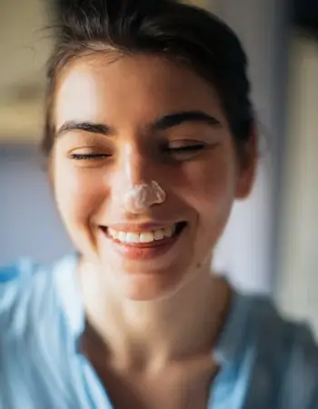 Girl with cream on the nose and smiling